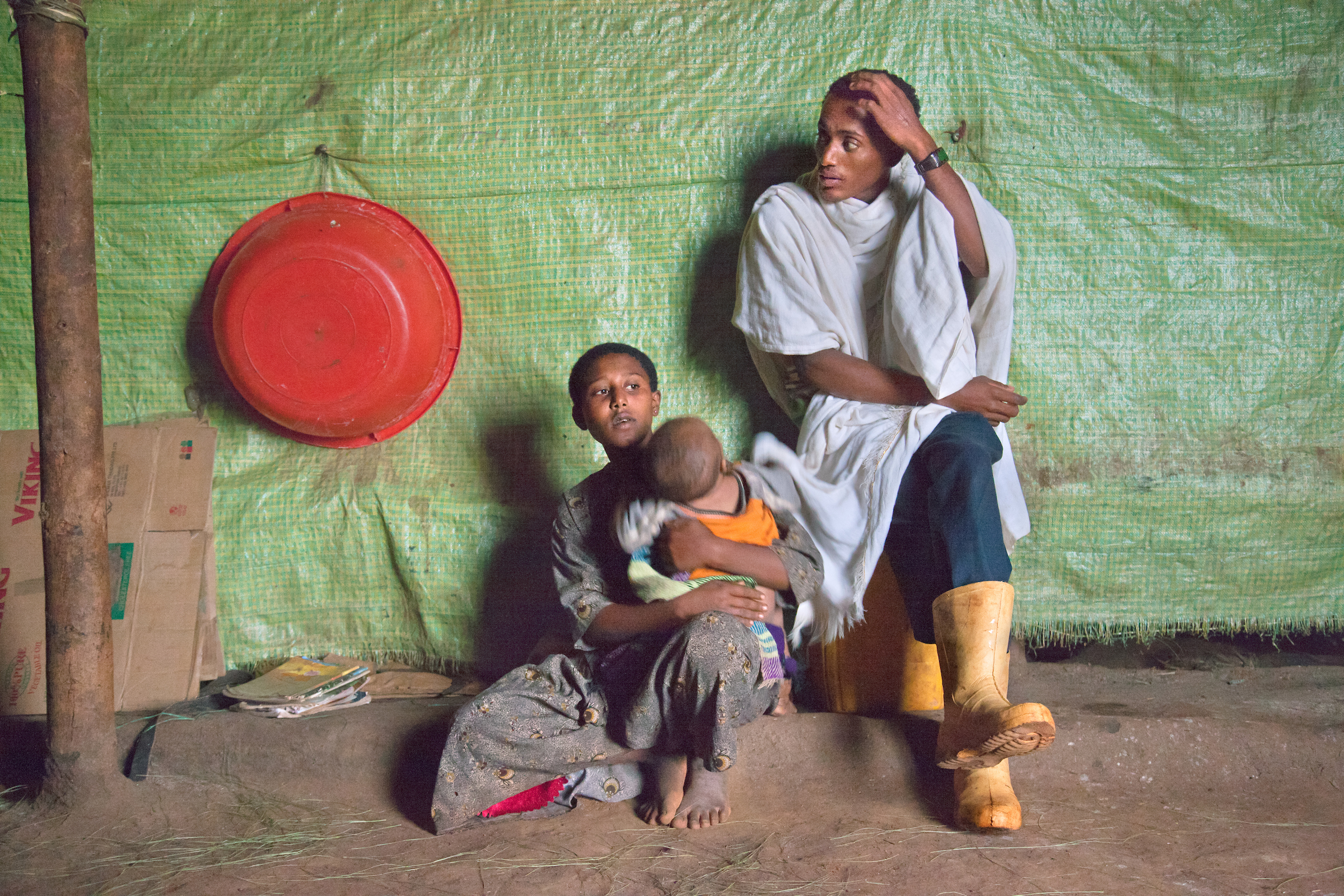 Fifteen-year- old Destaye and her husband Addisu, 27, at home with their son.