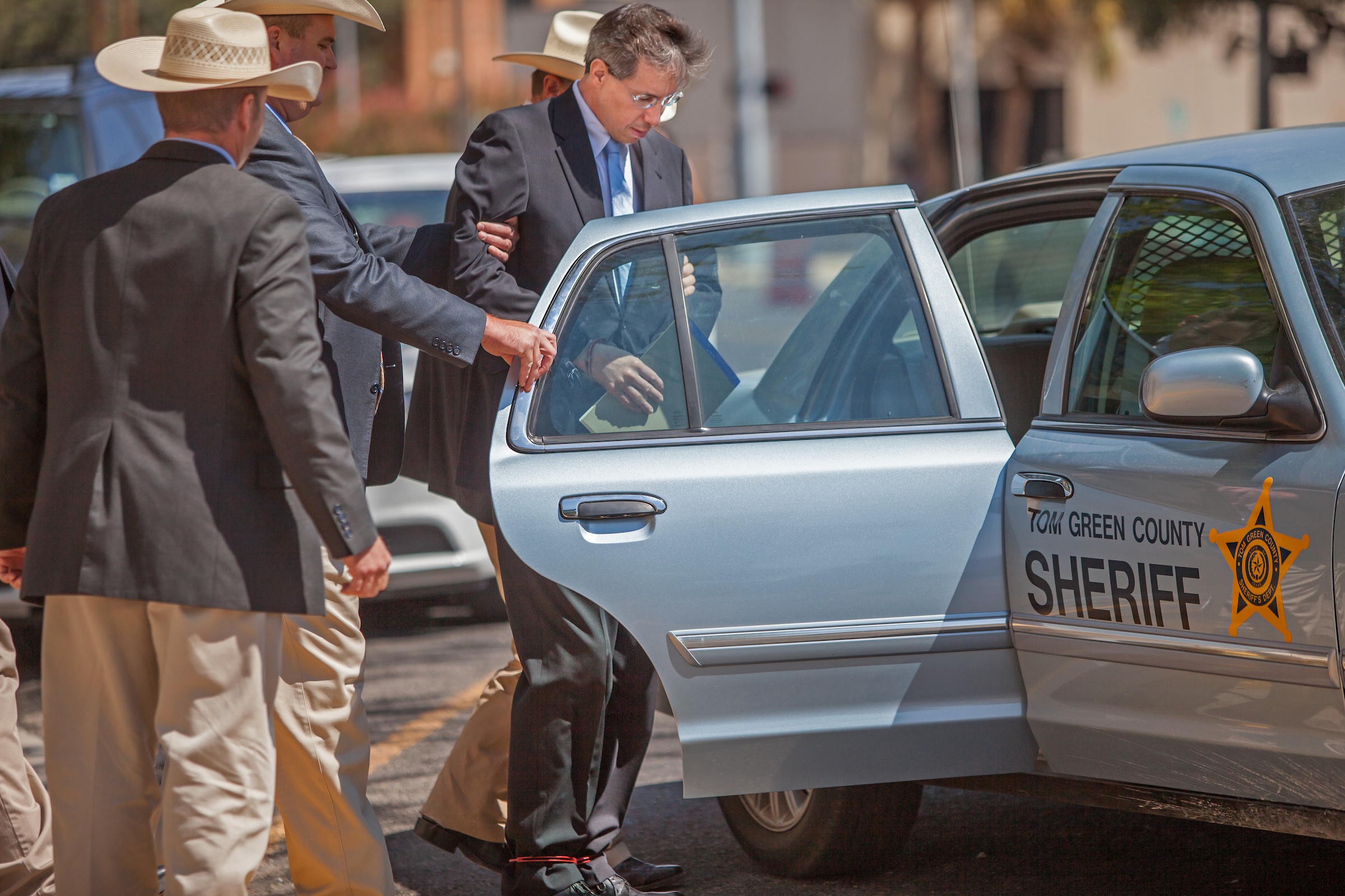 Warren S. Jeffs leaves his Texas trial in handcuffs.