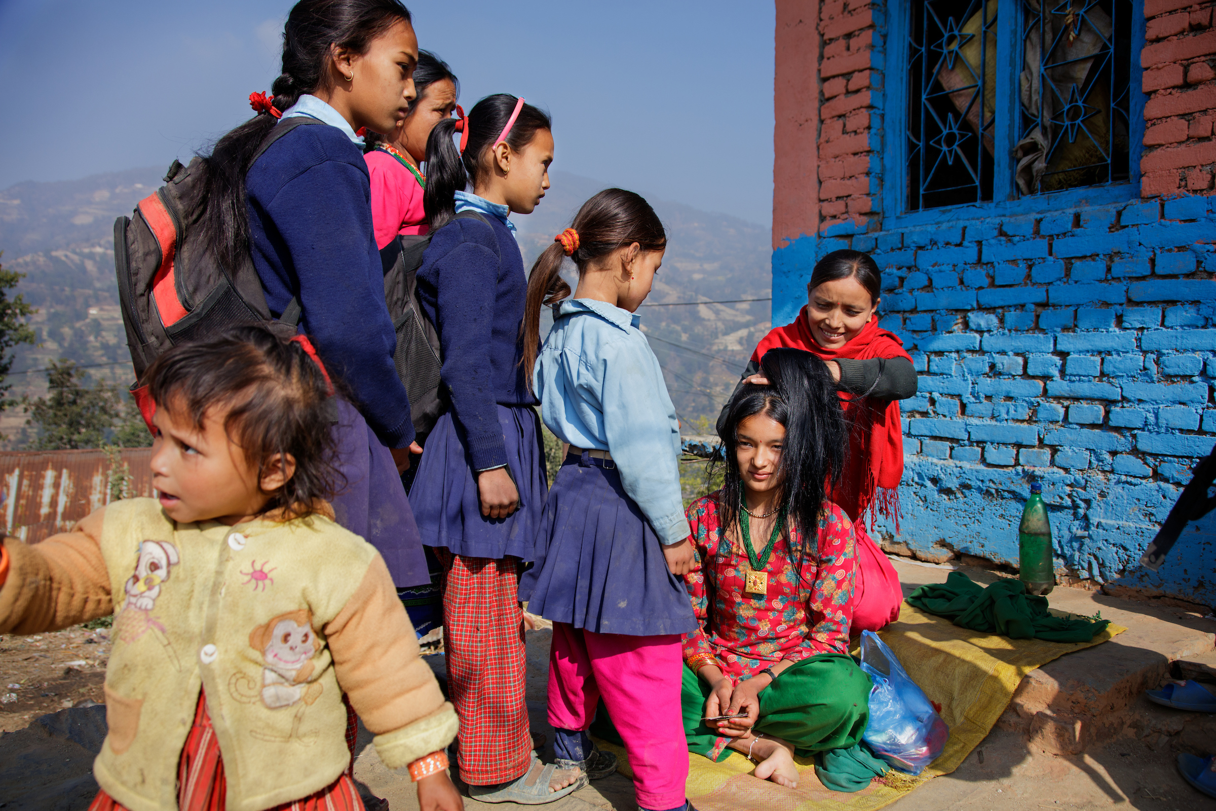 School girls watch as Anita, 16, is prepared to wed in Kagati village, Nepal.